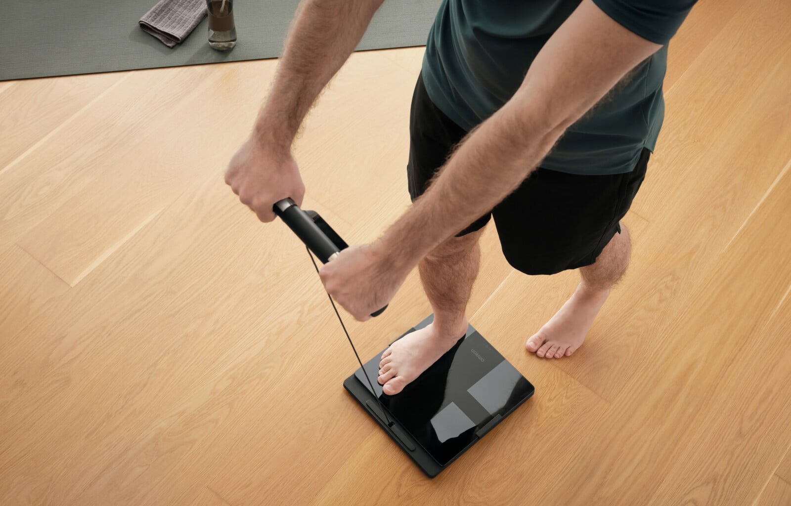 Man stepping on OMRON's body composition monitor + scale