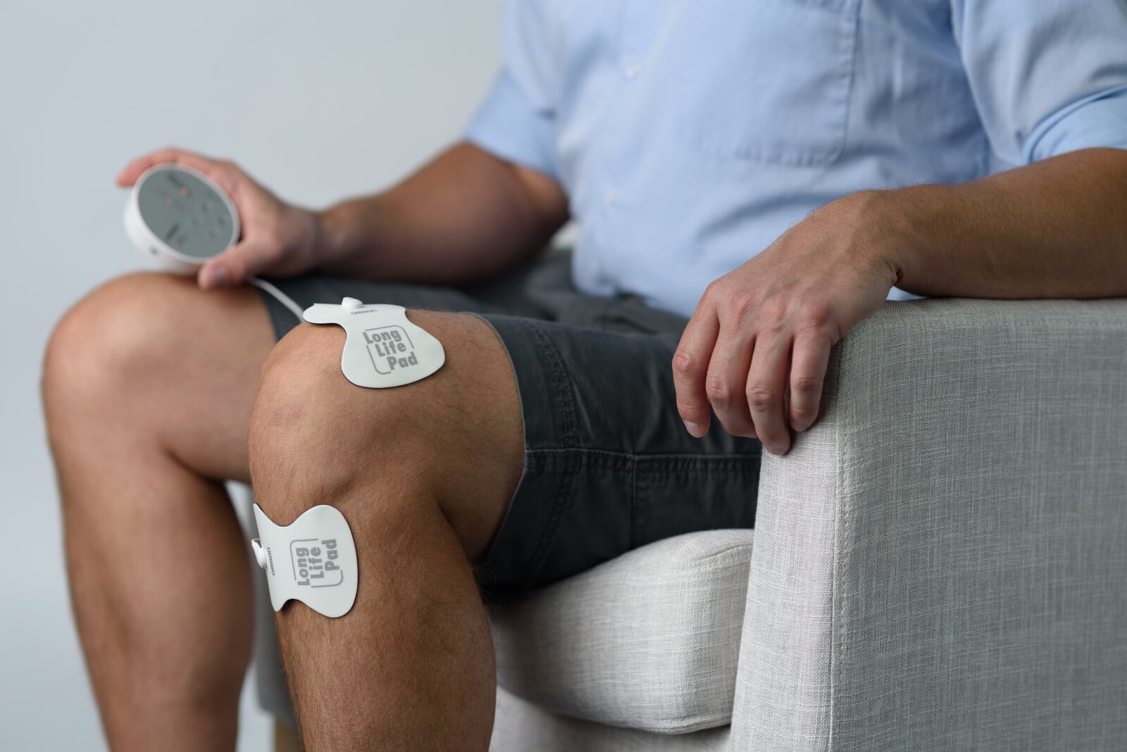 Close up image of someone using the TENS unit pads around their knee