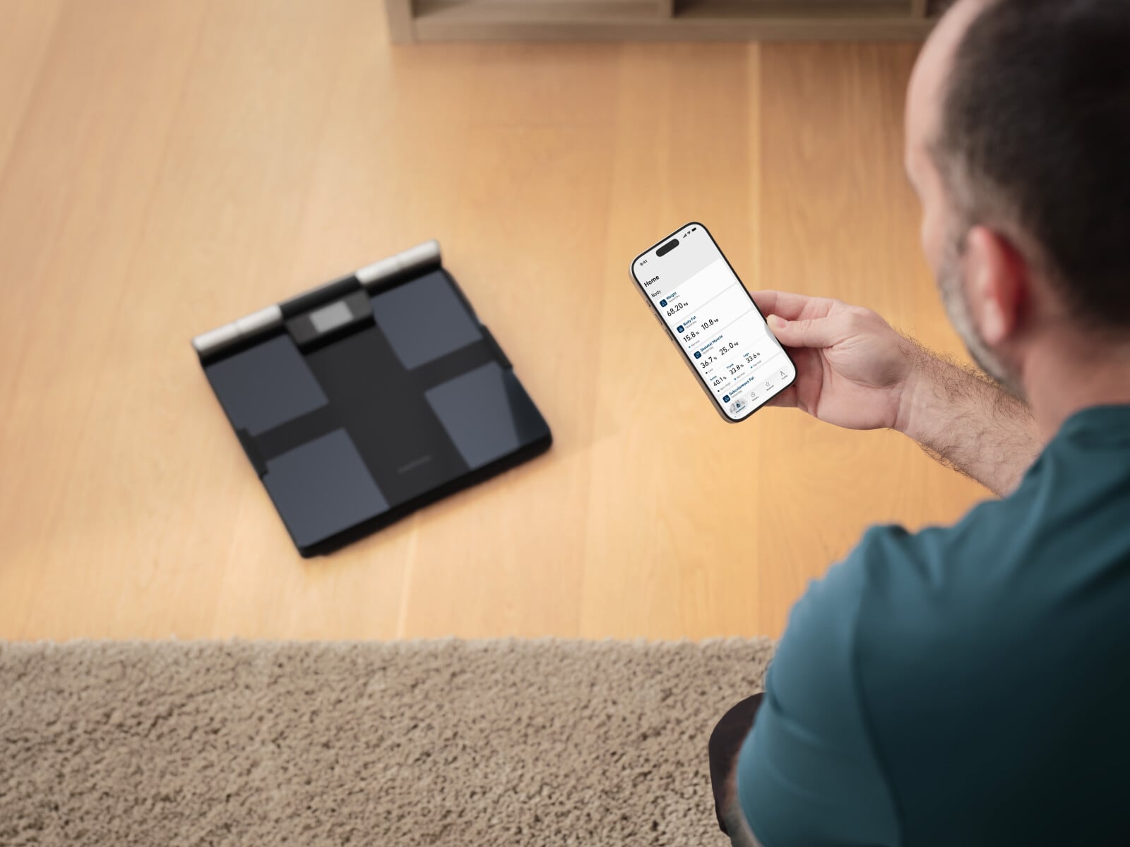 Man looking at phone and connecting to the scale in the background of the image