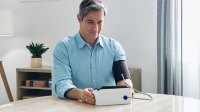 Man taking blood pressure at home