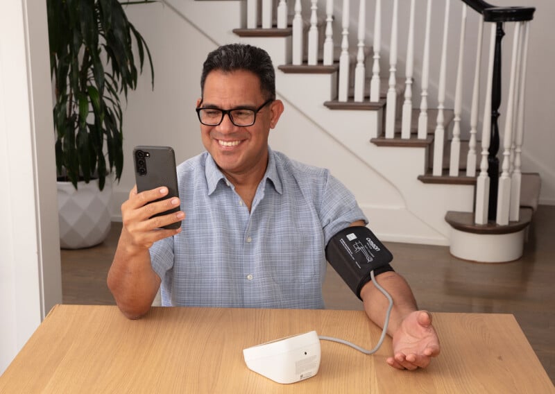 Man using blood pressure monitor device