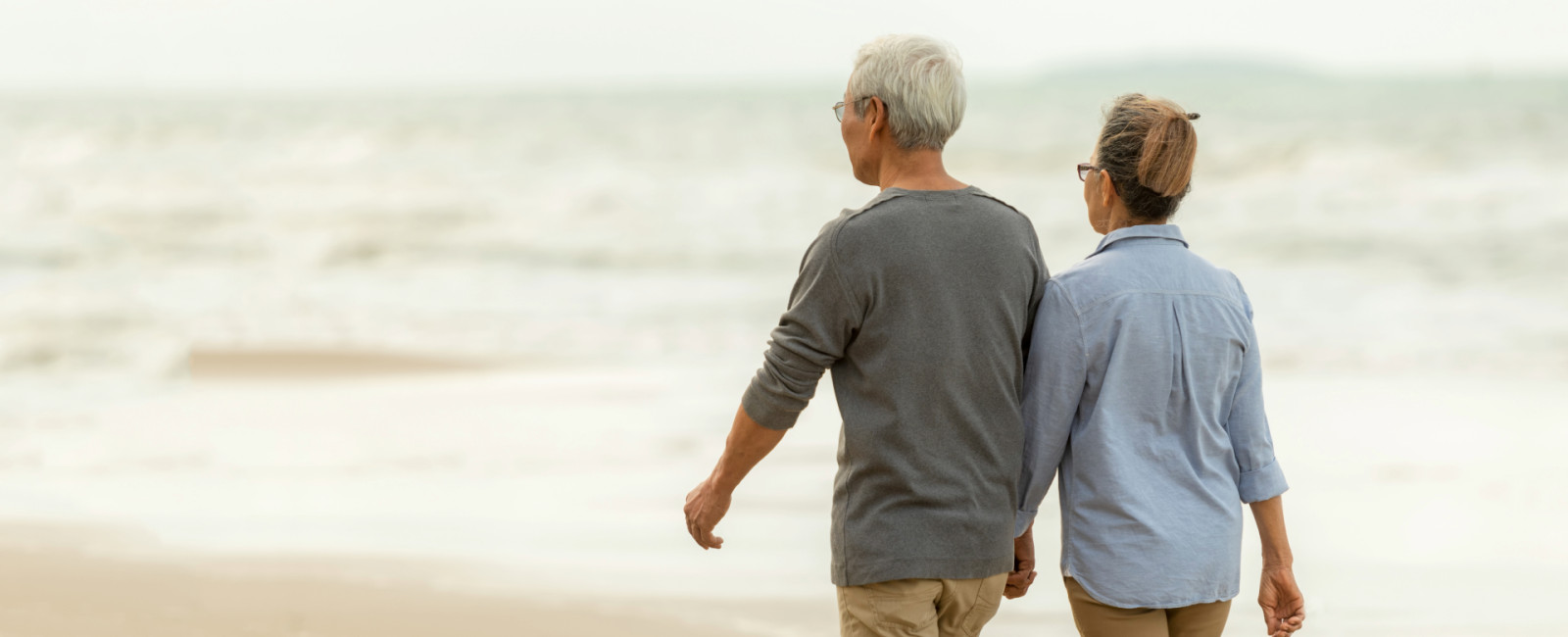 Man and woman walking on beach
