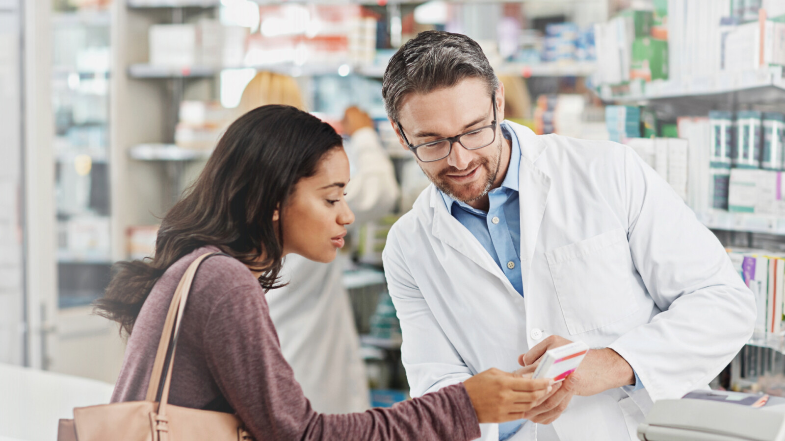 Pharmacist talking to customer