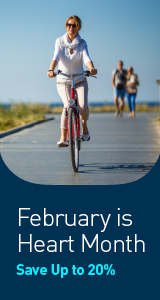 Woman riding bike on sidewalk. February is Heart Month. Save up to 20% off.